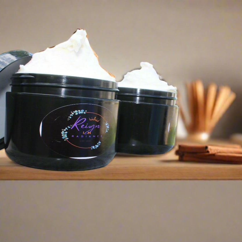 Two black containers with lids on a marble table outdoors.