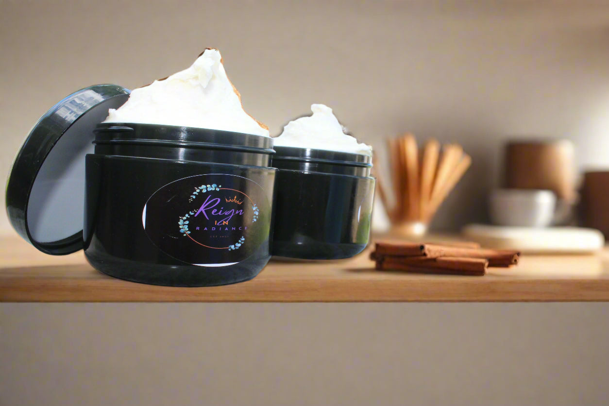 Two black containers with lids on a marble table outdoors.