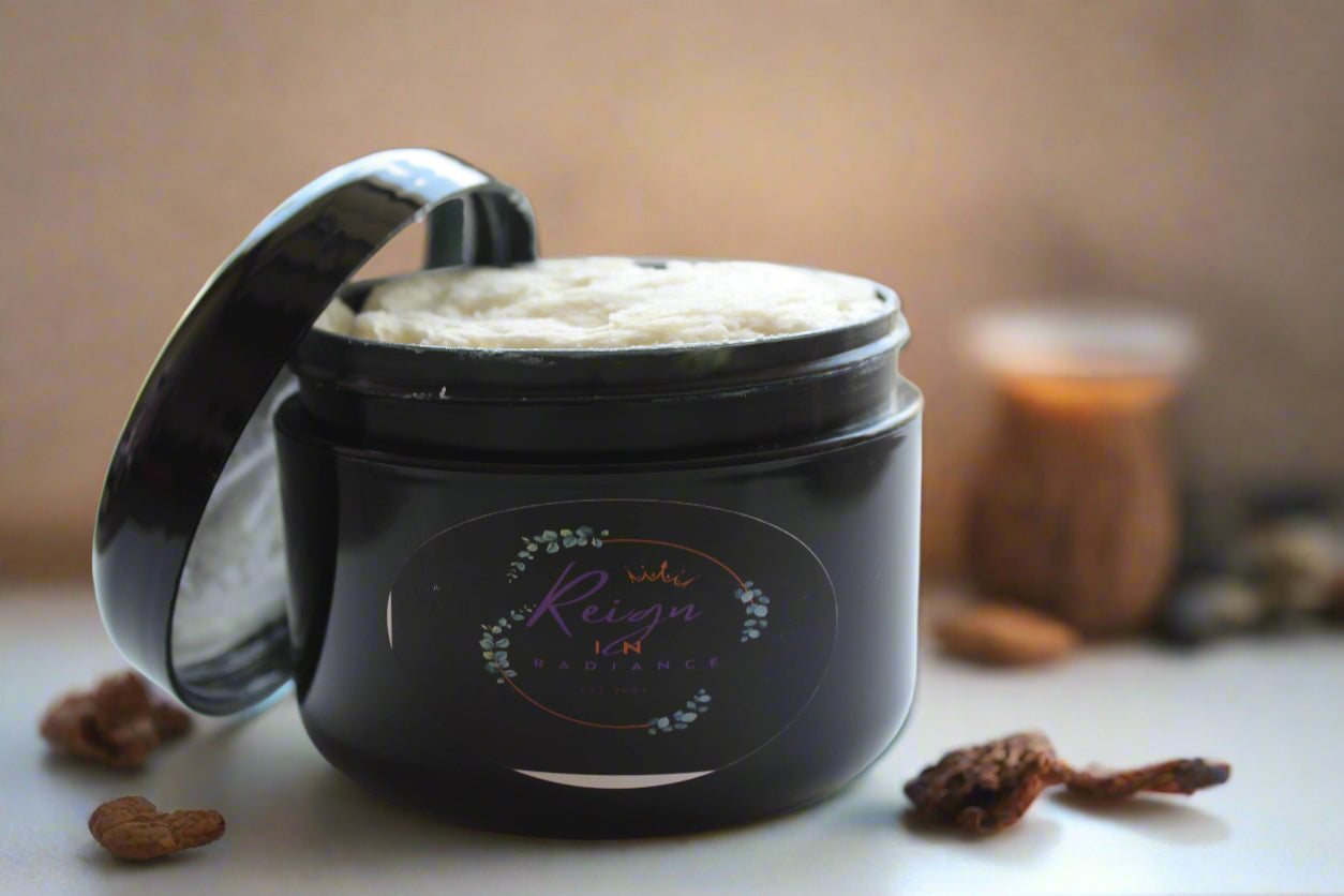 Black jar with a lid containing a white cream or paste, on a blurred background.